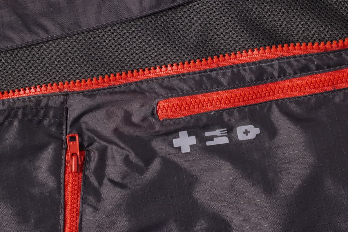Close view of a labeled pocket with an orange zipper
